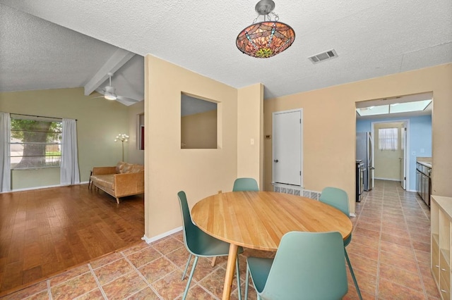 3921 Leafield Dr, Austin, TX 78749 - dining room featuring healthy amount of natural light, a textured ceiling, ceiling fan, baseboards, and light tile patterned floors