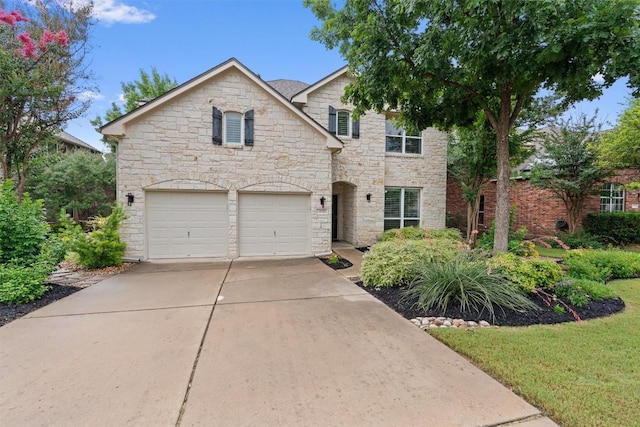 2125 Village View Loop, Pflugerville, TX 78660 - view of front of property featuring stone siding, a garage, and driveway