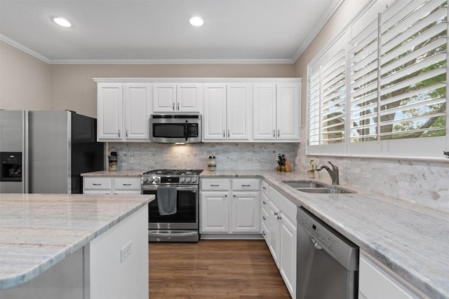 2125 Village View Loop, Pflugerville, TX 78660 - kitchen featuring appliances with stainless steel finishes, a sink, ornamental molding, white cabinetry, and recessed lighting