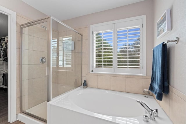 2125 Village View Loop, Pflugerville, TX 78660 - bathroom with a garden tub, a shower stall, and a walk in closet