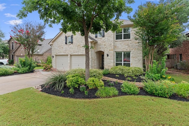 2125 Village View Loop, Pflugerville, TX 78660 - traditional-style house featuring stone siding, concrete driveway, a garage, and a front lawn