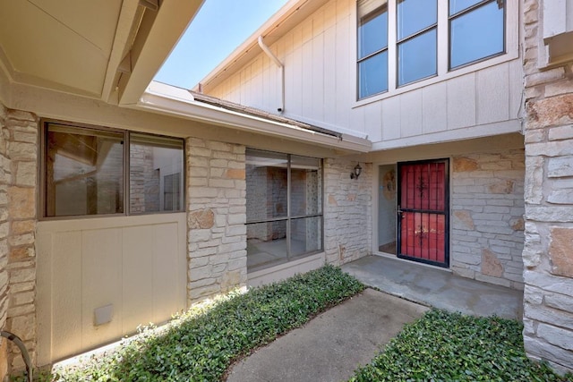 11512 Tin Cup Dr Unit 103, Austin, TX 78750 - doorway to property featuring stone siding and board and batten siding