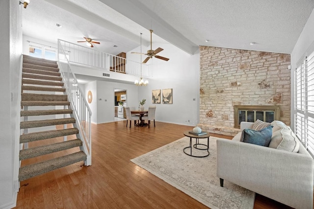 11512 Tin Cup Dr Unit 103, Austin, TX 78750 - living area with lofted ceiling, stairs, healthy amount of natural light, a textured ceiling, and wood finished floors