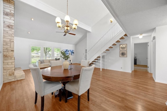 11512 Tin Cup Dr Unit 103, Austin, TX 78750 - dining area featuring a chandelier, stairs, light wood-style floors, and lofted ceiling