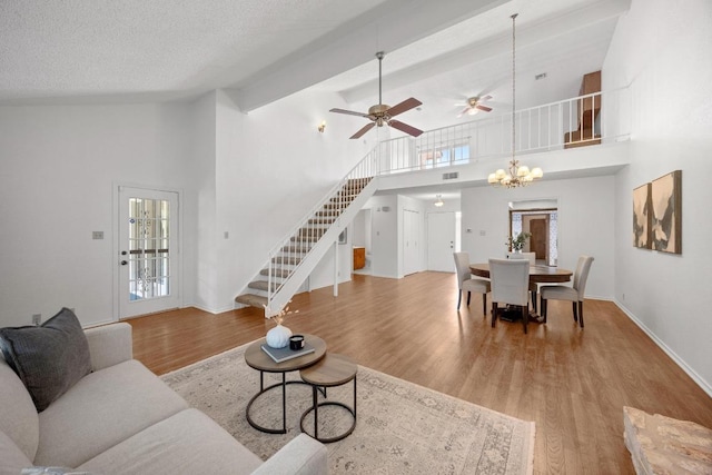 11512 Tin Cup Dr Unit 103, Austin, TX 78750 - living area featuring stairs, high vaulted ceiling, wood finished floors, ceiling fan, and baseboards