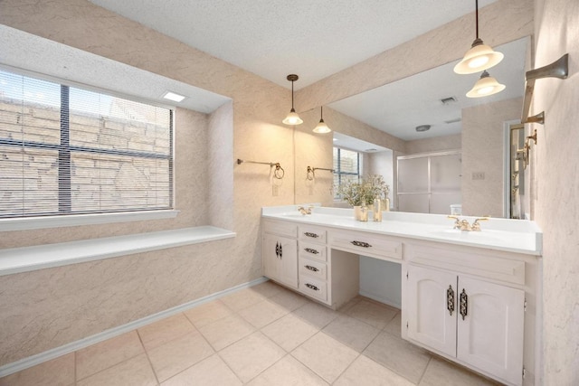 11512 Tin Cup Dr Unit 103, Austin, TX 78750 - full bathroom featuring double vanity, a shower stall, and tile patterned flooring