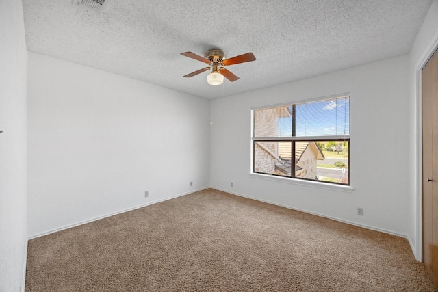 11512 Tin Cup Dr Unit 103, Austin, TX 78750 - empty room featuring a ceiling fan, carpet flooring, a textured ceiling, and baseboards