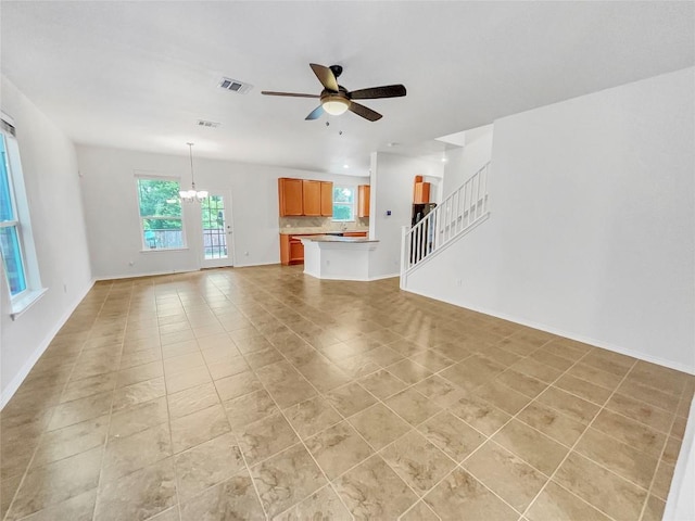 2015 Split Diamond Way, Round Rock, TX 78664 - unfurnished living room featuring a ceiling fan, a chandelier, stairway, light tile patterned floors, and baseboards
