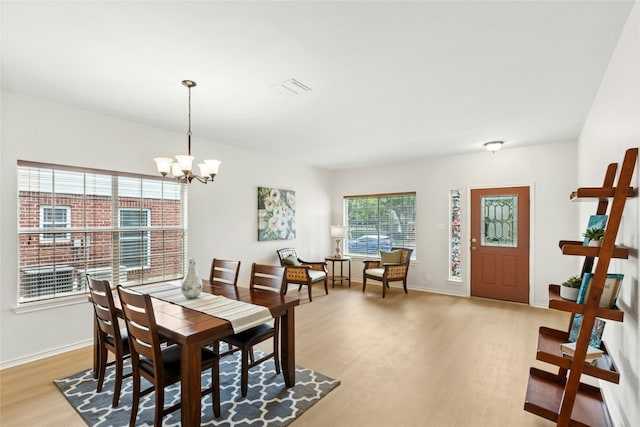 1113 Red Ranch Cir, Cedar Park, TX 78613 - dining room featuring light wood-type flooring, a chandelier, and baseboards