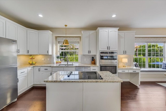 22 Wingreen Loop, The Hills, TX 78738 - kitchen with appliances with stainless steel finishes, a sink, white cabinetry, dark wood-type flooring, and recessed lighting