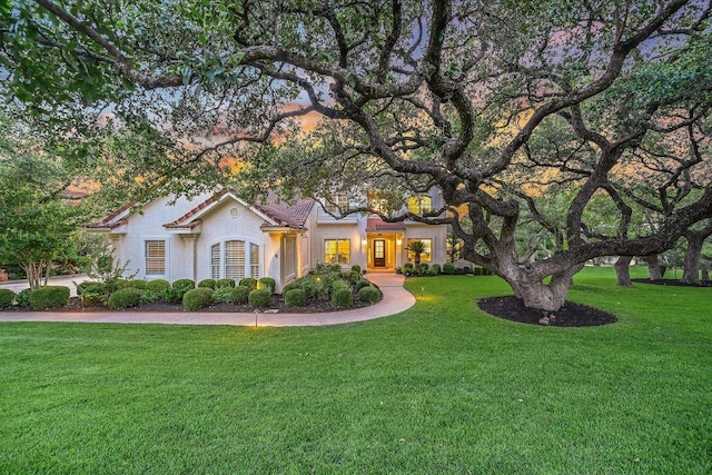 22 Wingreen Loop, The Hills, TX 78738 - view of front of house featuring a front lawn and stucco siding
