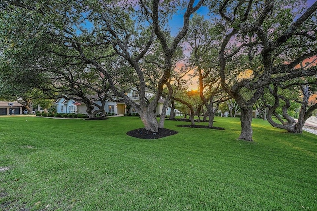 22 Wingreen Loop, The Hills, TX 78738 - yard at dusk featuring a lawn