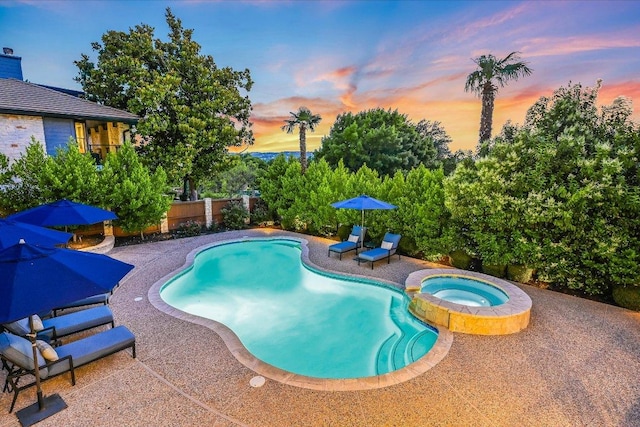 22 Wingreen Loop, The Hills, TX 78738 - pool at dusk featuring a patio area, a fenced backyard, and a pool with connected hot tub