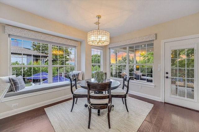 22 Wingreen Loop, The Hills, TX 78738 - dining space with a chandelier, baseboards, and wood finished floors