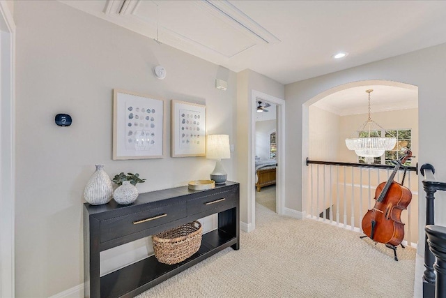 22 Wingreen Loop, The Hills, TX 78738 - hallway with attic access, carpet floors, baseboards, arched walkways, and ornamental molding
