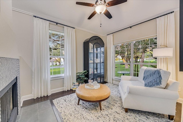 22 Wingreen Loop, The Hills, TX 78738 - living area featuring a fireplace, ceiling fan, baseboards, and arched walkways
