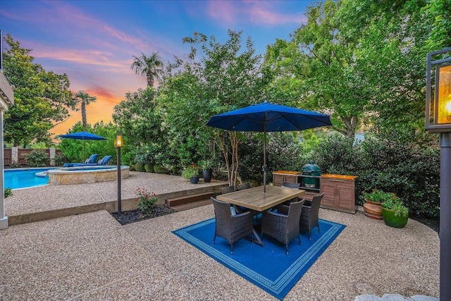 22 Wingreen Loop, The Hills, TX 78738 - patio terrace at dusk with a patio area, outdoor dining area, and a pool with connected hot tub