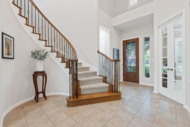 3022 Luminoso Ln E, Round Rock, TX 78681 - entrance foyer with a high ceiling, healthy amount of natural light, stairs, and light tile patterned flooring