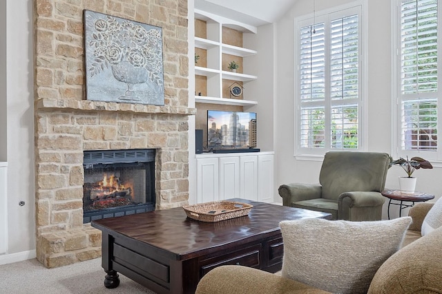 3022 Luminoso Ln E, Round Rock, TX 78681 - carpeted living area featuring a fireplace, plenty of natural light, and baseboards