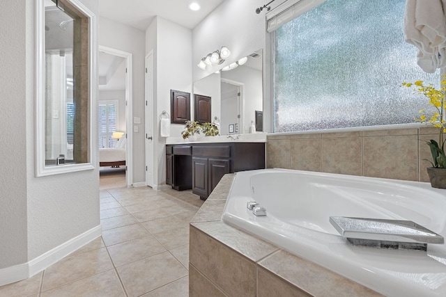 3022 Luminoso Ln E, Round Rock, TX 78681 - bathroom with a garden tub, vanity, tile patterned flooring, baseboards, and connected bathroom