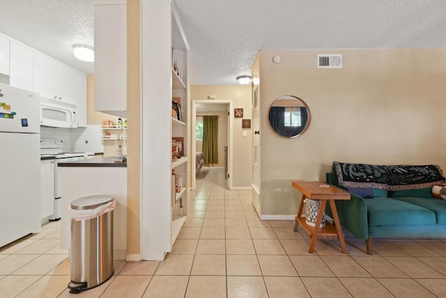 801 Terrell Hill Dr, Austin, TX 78704 - hall featuring a textured ceiling and light tile patterned flooring