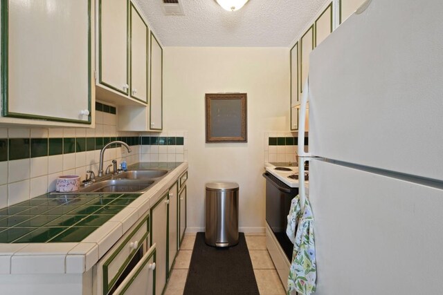 801 Terrell Hill Dr, Austin, TX 78704 - kitchen with white appliances, tile countertops, a sink, tasteful backsplash, and light tile patterned floors