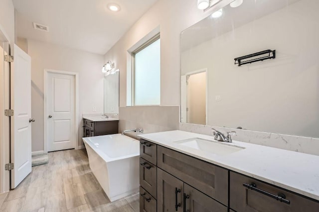149 Woods Edge Ln, Georgetown, TX 78628 - bathroom with a freestanding tub and two vanities