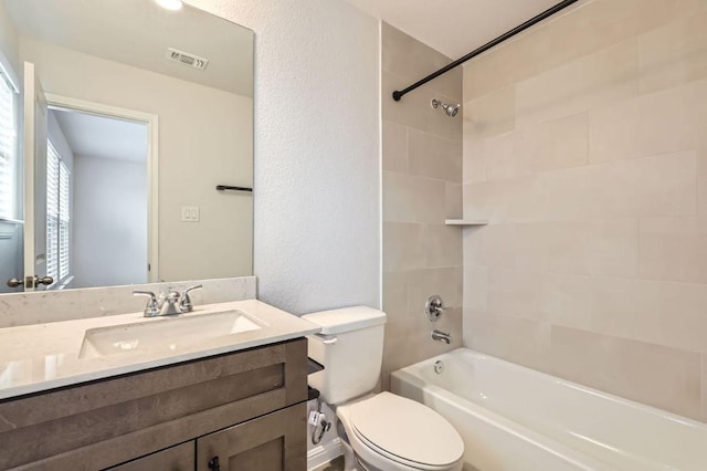 149 Woods Edge Ln, Georgetown, TX 78628 - bathroom with toilet, vanity, bathing tub / shower combination, and a textured wall