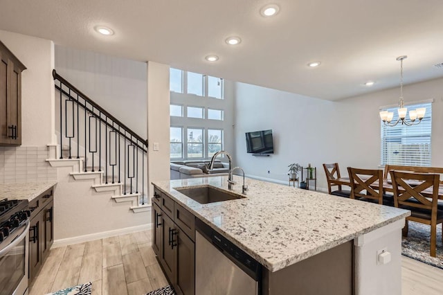 149 Woods Edge Ln, Georgetown, TX 78628 - kitchen featuring stainless steel appliances, a sink, plenty of natural light, recessed lighting, and a center island with sink