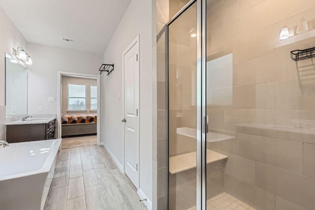 149 Woods Edge Ln, Georgetown, TX 78628 - bathroom featuring a stall shower, a freestanding tub, vanity, and ensuite bathroom