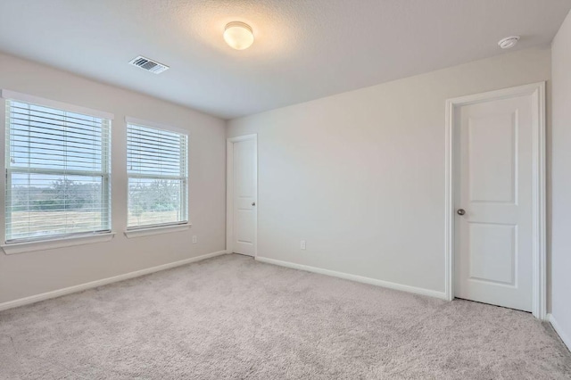 149 Woods Edge Ln, Georgetown, TX 78628 - unfurnished room featuring light colored carpet, baseboards, and a smoke detector