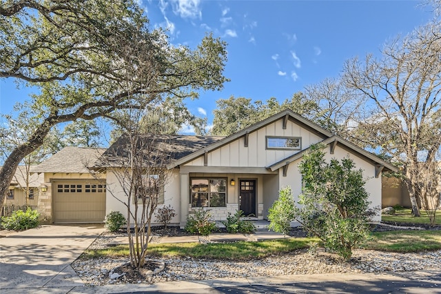 9707 Anderson Mill Rd Unit 32, Austin, TX 78750 - view of front facade featuring an attached garage, concrete driveway, roof with shingles, board and batten siding, and stucco siding