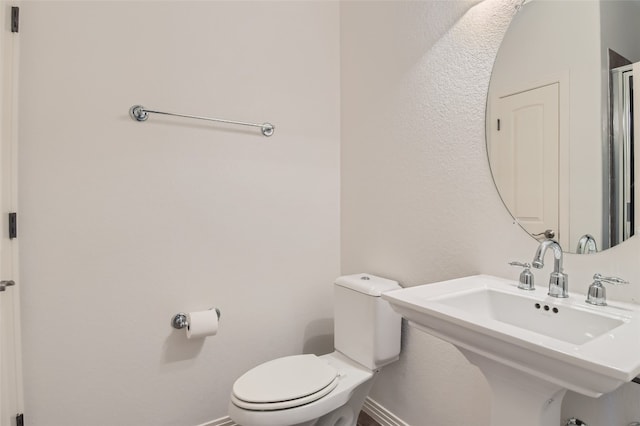 9707 Anderson Mill Rd Unit 32, Austin, TX 78750 - half bathroom featuring toilet, baseboards, and a sink