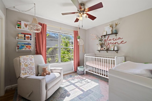 1308 Berkshire Dr, Austin, TX 78723 - bedroom featuring a crib, ceiling fan, and baseboards