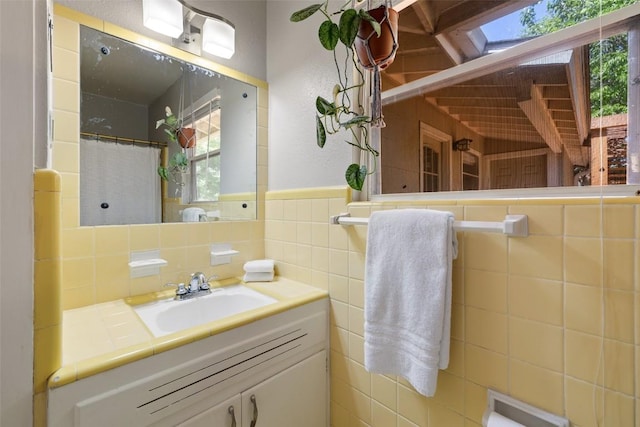 1308 Berkshire Dr, Austin, TX 78723 - bathroom with tile walls, vanity, wainscoting, and a textured wall