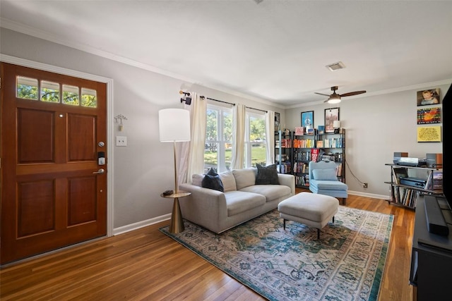 1308 Berkshire Dr, Austin, TX 78723 - living room with healthy amount of natural light, wood finished floors, baseboards, and ornamental molding