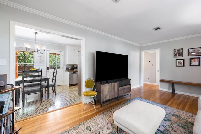 1308 Berkshire Dr, Austin, TX 78723 - living area with light wood finished floors, a chandelier, crown molding, and baseboards