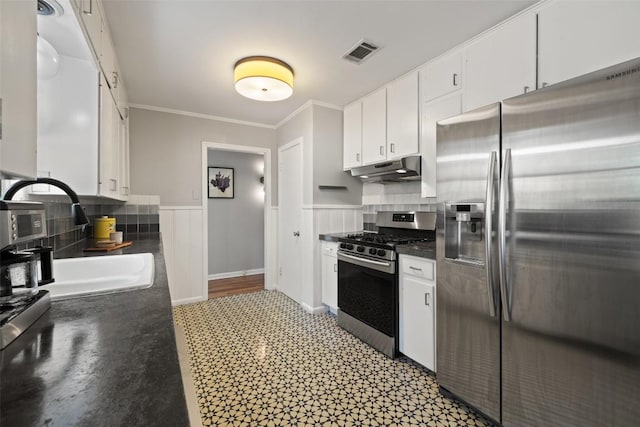 1308 Berkshire Dr, Austin, TX 78723 - kitchen featuring stainless steel appliances, a sink, ornamental molding, dark countertops, and under cabinet range hood