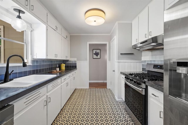 1308 Berkshire Dr, Austin, TX 78723 - kitchen featuring appliances with stainless steel finishes, under cabinet range hood, a sink, white cabinetry, and ornamental molding
