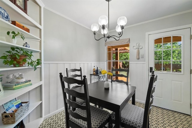 1308 Berkshire Dr, Austin, TX 78723 - dining room featuring light floors, wainscoting, a chandelier, crown molding, and a decorative wall