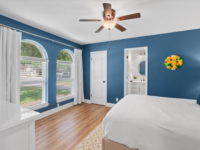 2600 Cockburn Dr, Austin, TX 78745 - bedroom with light wood finished floors, ensuite bath, and a ceiling fan