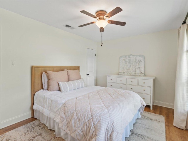 2600 Cockburn Dr, Austin, TX 78745 - bedroom with light wood finished floors and ceiling fan