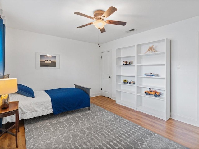 2600 Cockburn Dr, Austin, TX 78745 - bedroom with wood finished floors and ceiling fan