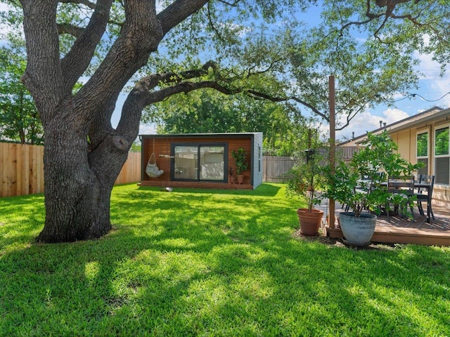 2600 Cockburn Dr, Austin, TX 78745 - fenced backyard with an outdoor structure and a deck