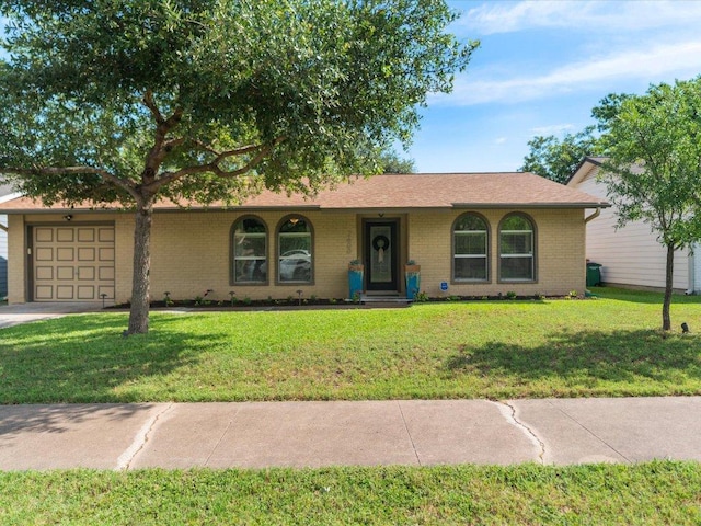 2600 Cockburn Dr, Austin, TX 78745 - ranch-style home with a garage, a front lawn, and brick siding