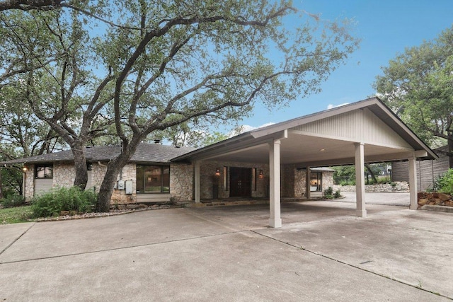 3902 Knollwood Dr Unit A, Austin, TX 78731 - view of front facade featuring concrete driveway, stone siding, and an attached carport