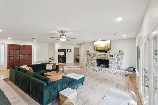 3902 Knollwood Dr Unit A, Austin, TX 78731 - living room featuring a stone fireplace, ceiling fan, recessed lighting, and light wood finished floors