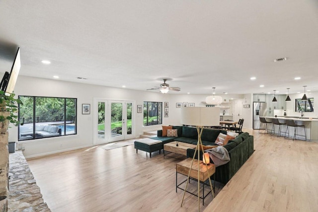 3902 Knollwood Dr Unit A, Austin, TX 78731 - living area featuring light wood-type flooring, recessed lighting, ceiling fan, french doors, and baseboards