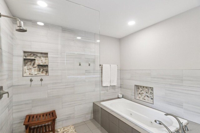 3902 Knollwood Dr Unit A, Austin, TX 78731 - bathroom with a tub with jets, tile walls, tile patterned floors, recessed lighting, and tiled shower