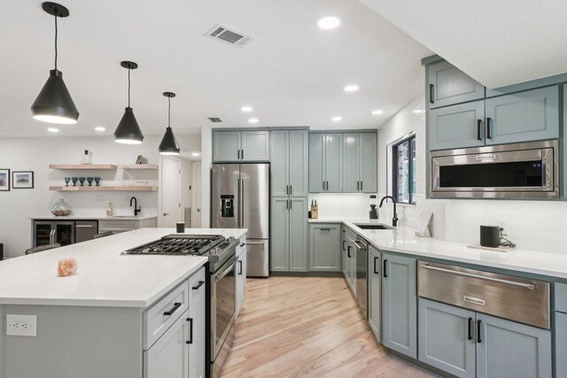 3902 Knollwood Dr Unit A, Austin, TX 78731 - kitchen with premium appliances, a warming drawer, light countertops, light wood-type flooring, and recessed lighting